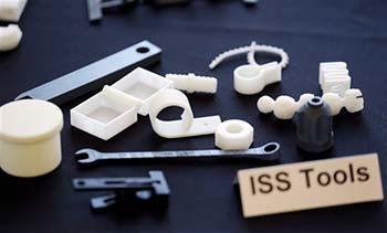 Tools and parts made by a 3D printer are displayed at Made in Space